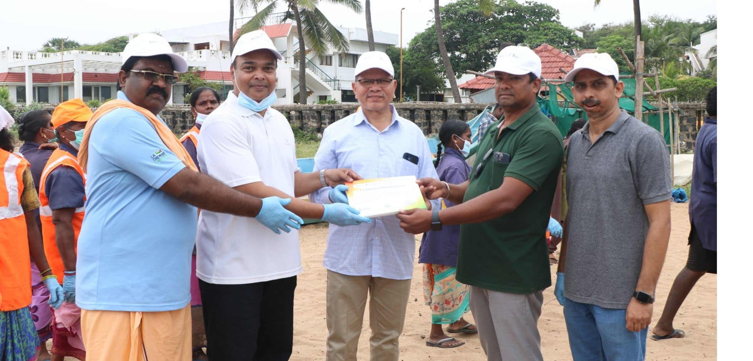 Participants collecting waste along Kalapet Beach